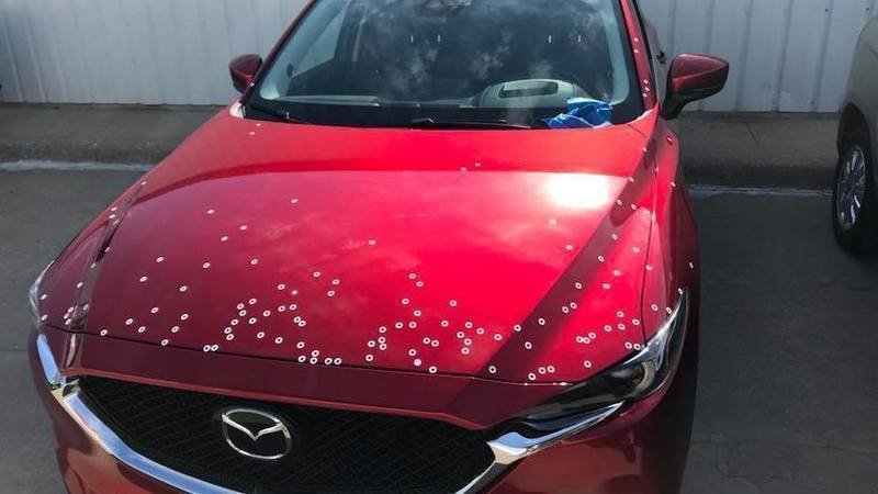 Red Mazda with white paint spots
